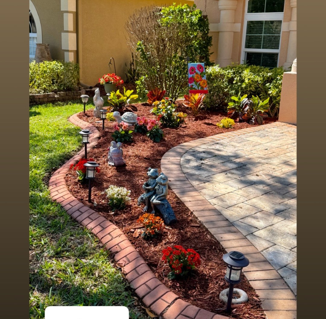 Front flower bed redone with fresh mulch, flowers and edging — after